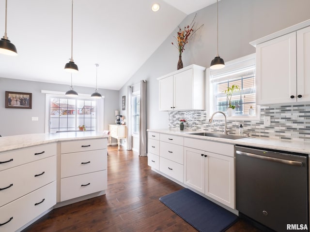 kitchen with dishwasher, light countertops, a sink, and a wealth of natural light