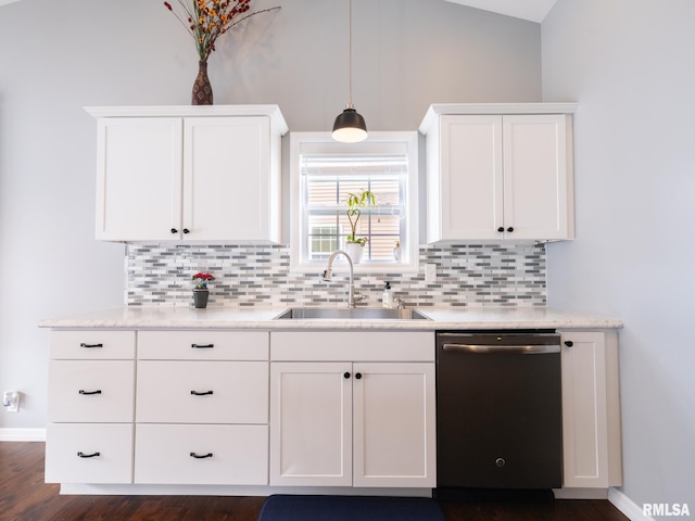 kitchen featuring tasteful backsplash, white cabinetry, vaulted ceiling, a sink, and dishwasher