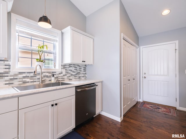 kitchen with dark wood-type flooring, a sink, vaulted ceiling, backsplash, and dishwasher