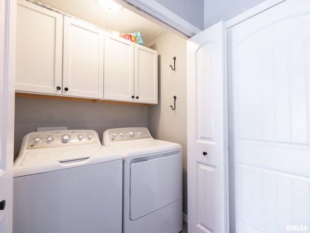 washroom with cabinet space and washer and clothes dryer