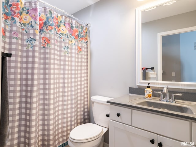 full bath featuring toilet, a shower with shower curtain, and vanity