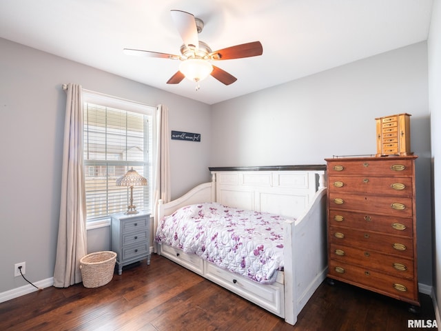 bedroom with ceiling fan, baseboards, and dark wood finished floors