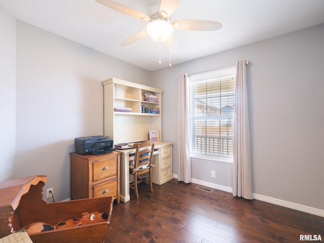 office space featuring a ceiling fan, visible vents, dark wood finished floors, and baseboards