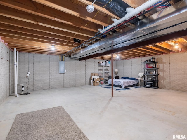 unfinished basement with brick wall and electric panel