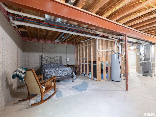 unfinished below grade area featuring heating unit, brick wall, and water heater