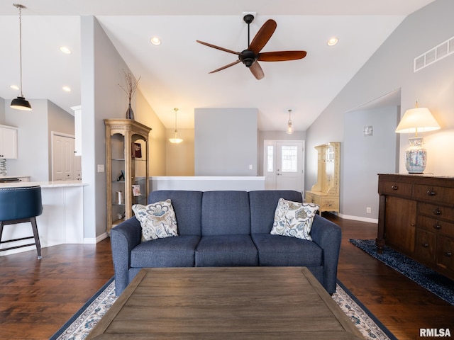 living room featuring lofted ceiling, a ceiling fan, visible vents, and dark wood-type flooring