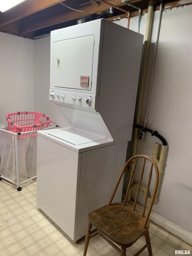 washroom with laundry area, light floors, and stacked washer and clothes dryer