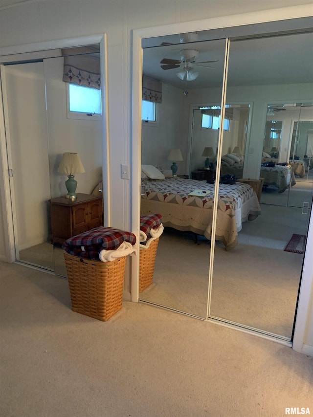 bedroom with carpet floors and two closets