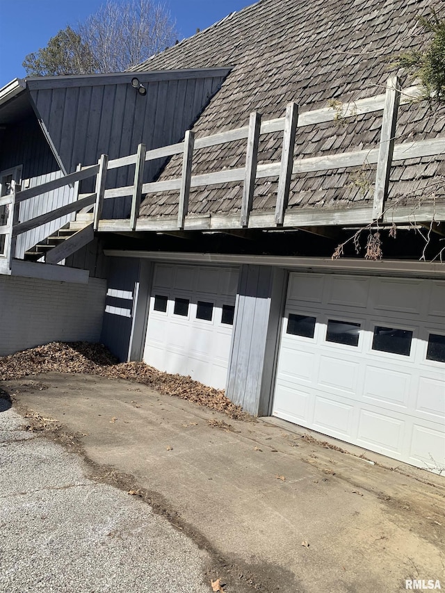 view of side of home featuring concrete driveway