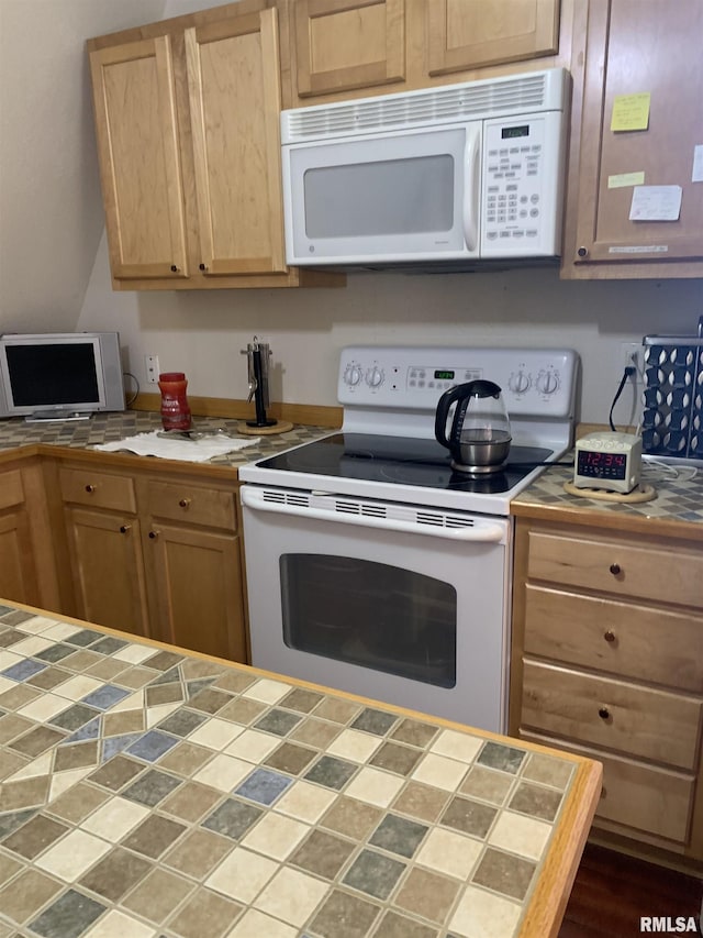 kitchen featuring white appliances, light brown cabinets, and tile counters