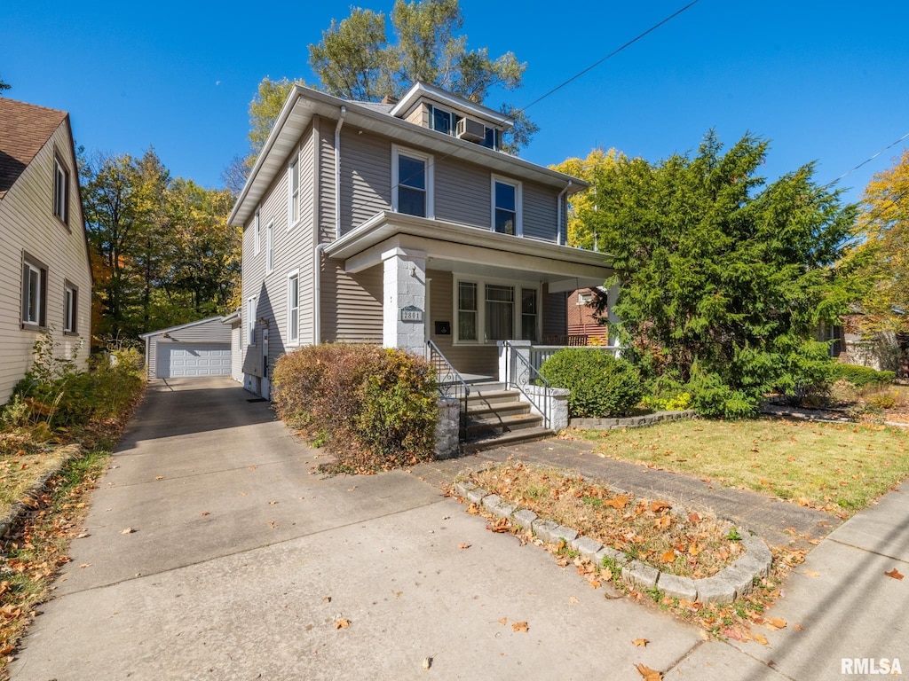 traditional style home with an outdoor structure, a porch, and a detached garage