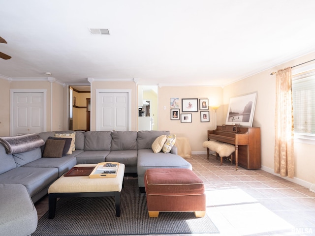 living area featuring light tile patterned floors, ornamental molding, visible vents, and baseboards