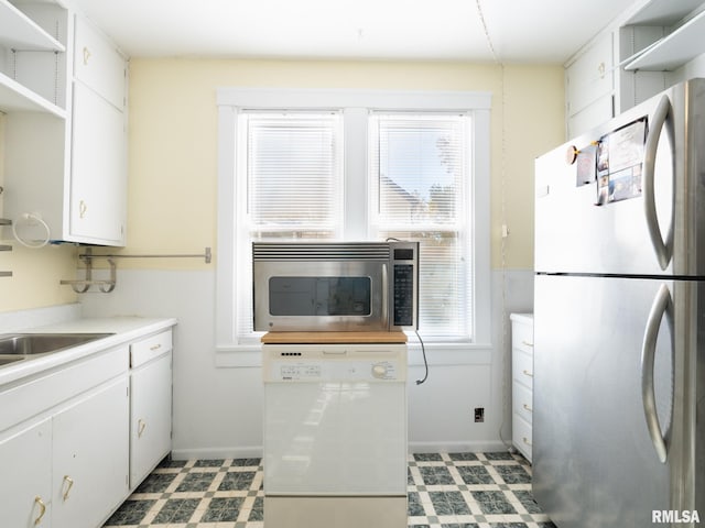 kitchen featuring stainless steel appliances, light countertops, light floors, white cabinetry, and open shelves