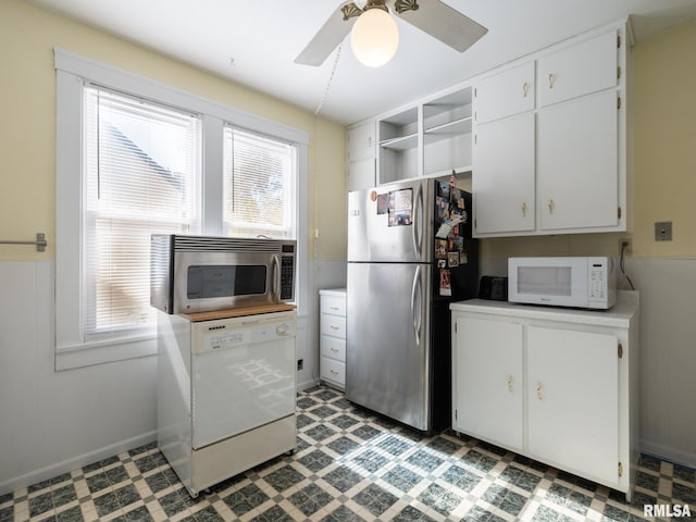 kitchen featuring light floors, appliances with stainless steel finishes, and a healthy amount of sunlight