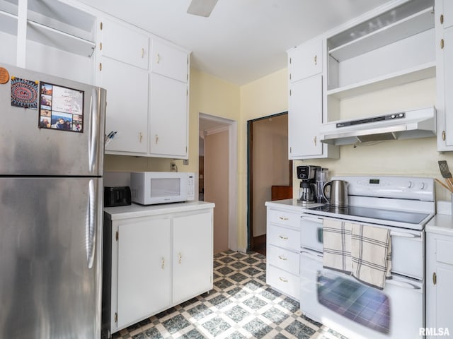 kitchen with under cabinet range hood, white appliances, white cabinets, light countertops, and light floors