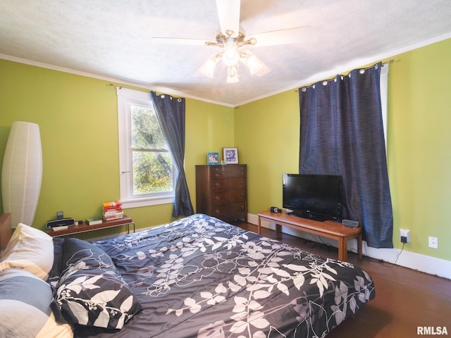 bedroom with a textured ceiling, ceiling fan, wood finished floors, baseboards, and ornamental molding