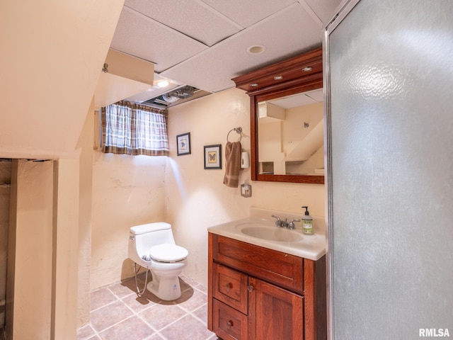 bathroom with tile patterned flooring, vanity, and toilet