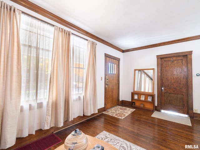 entryway featuring baseboards, wood finished floors, and crown molding