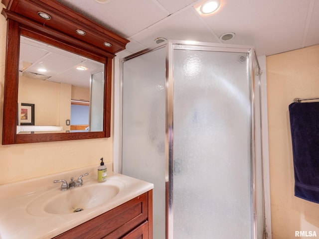 full bath with a shower stall and vanity