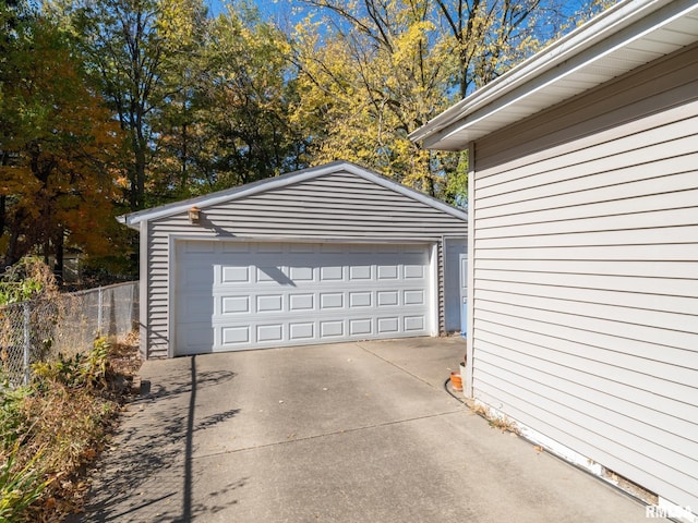 detached garage featuring fence