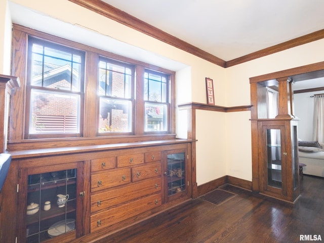 living area with plenty of natural light, ornamental molding, and dark wood finished floors