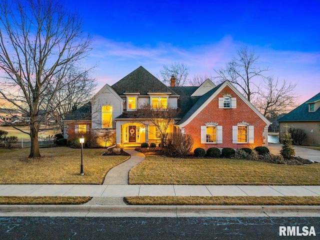 traditional home with brick siding and a chimney