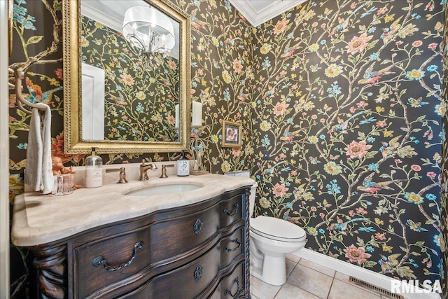 half bath with ornamental molding, vanity, toilet, and tile patterned floors