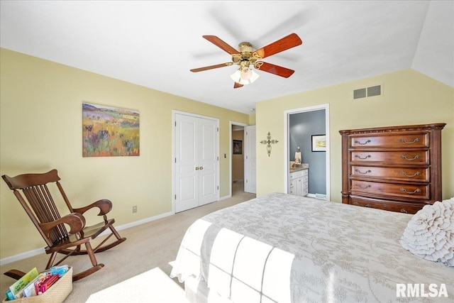 bedroom with visible vents, a ceiling fan, light carpet, ensuite bath, and baseboards