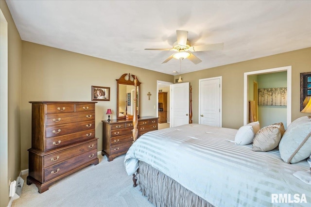 bedroom featuring light colored carpet and ceiling fan