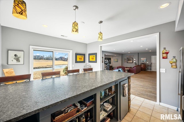 kitchen featuring light tile patterned floors, visible vents, dark countertops, pendant lighting, and recessed lighting