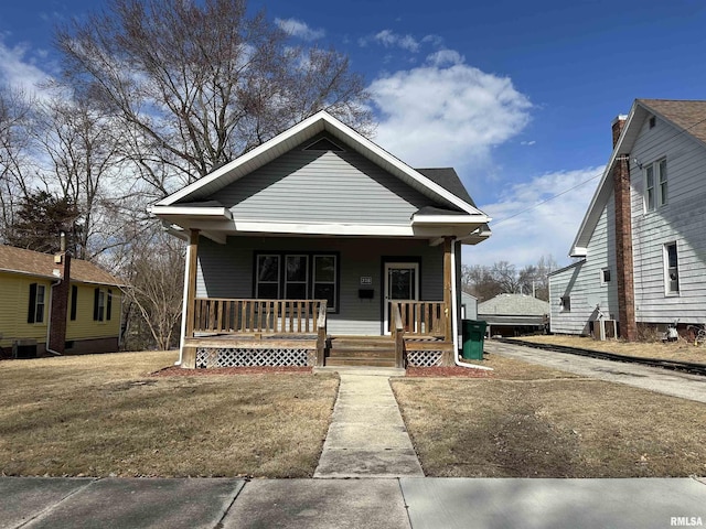 bungalow with a porch and concrete driveway