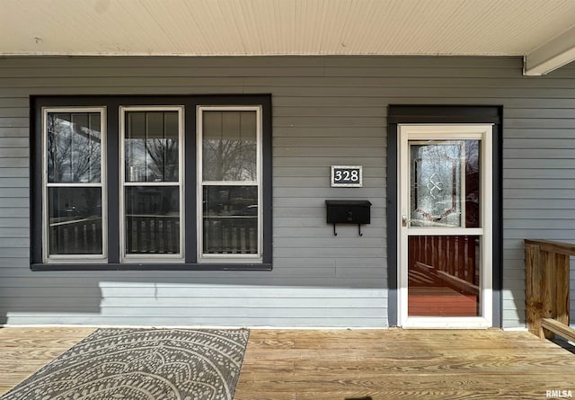 view of exterior entry featuring a porch