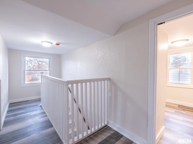 stairs with wood finished floors and baseboards