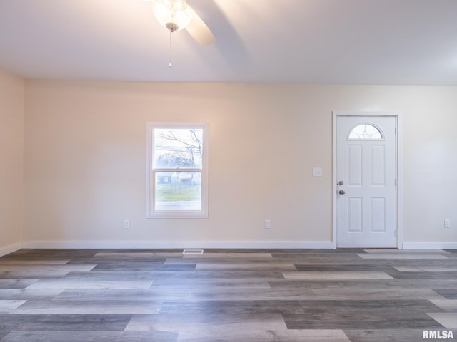 foyer with a ceiling fan, baseboards, and wood finished floors