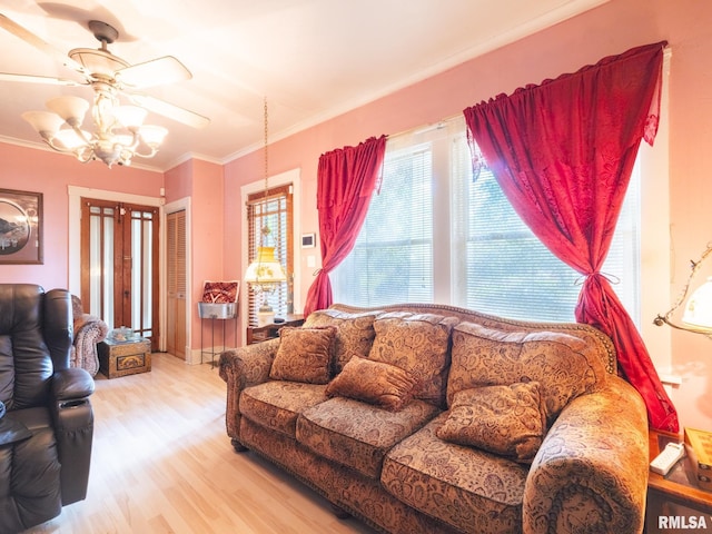 living room featuring ornamental molding, wood finished floors, and a ceiling fan