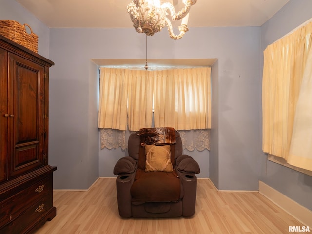 sitting room with a chandelier and light wood-style flooring