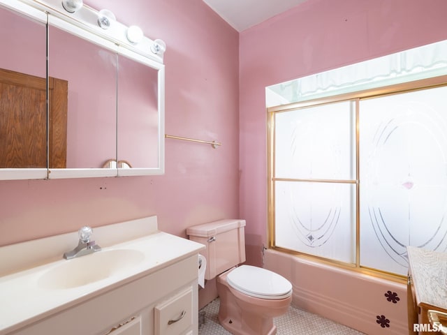 full bath with toilet, bath / shower combo with glass door, and vanity