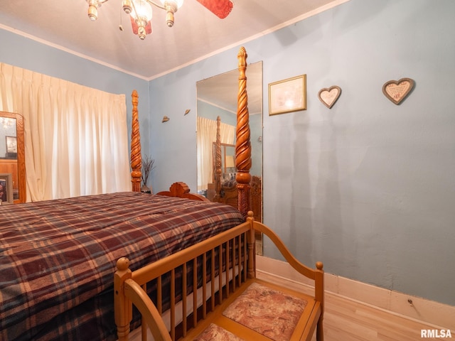 bedroom featuring baseboards and wood finished floors