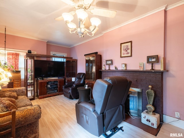 living room with a chandelier, ornamental molding, a brick fireplace, and wood finished floors