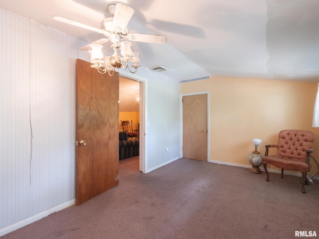 unfurnished room featuring lofted ceiling, baseboards, visible vents, and carpet