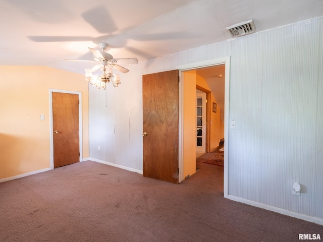 carpeted spare room with visible vents, ceiling fan, and baseboards