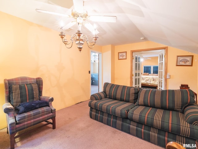 living area featuring a ceiling fan, vaulted ceiling, and carpet flooring