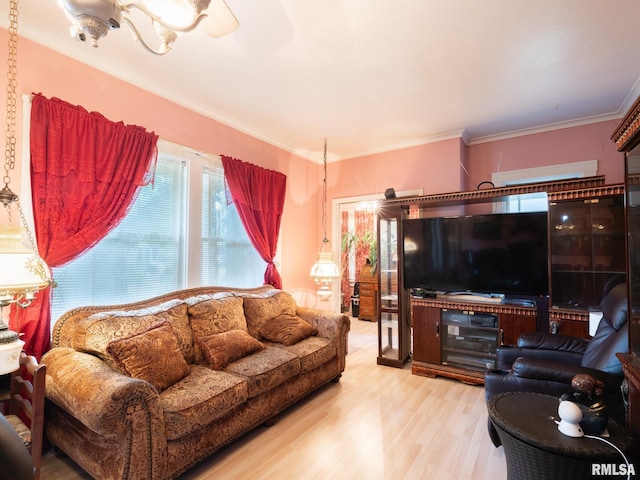 living area featuring ornamental molding and wood finished floors