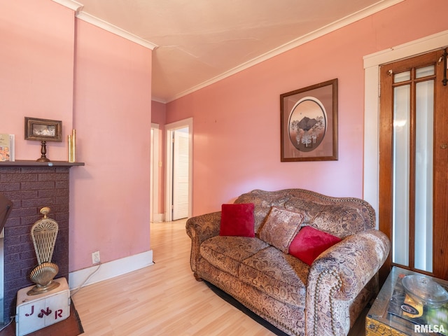 living room featuring ornamental molding, a fireplace, wood finished floors, and baseboards