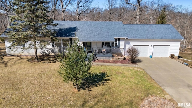 ranch-style house featuring a shingled roof, covered porch, a front yard, a garage, and driveway