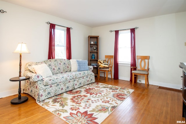 living room featuring wood-type flooring and baseboards