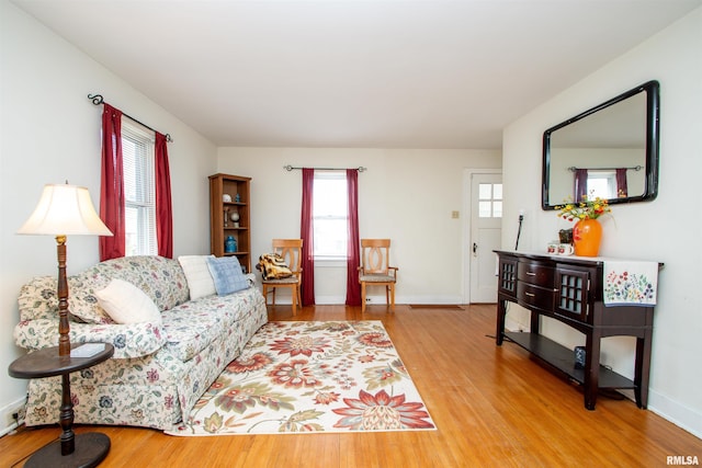 living room featuring plenty of natural light, baseboards, and wood finished floors