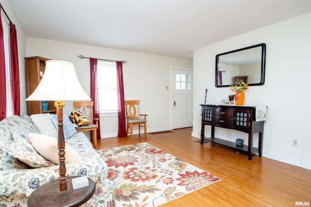 living area featuring baseboards and wood finished floors