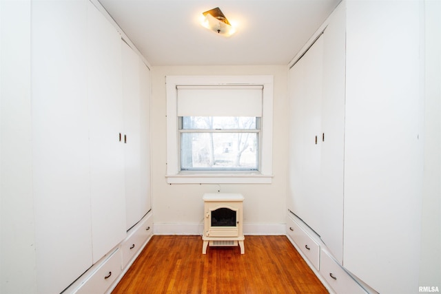 interior space featuring baseboards and wood finished floors