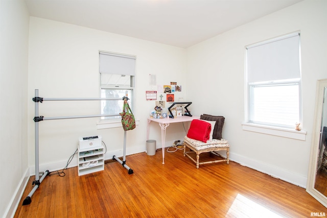 interior space featuring baseboards and wood finished floors